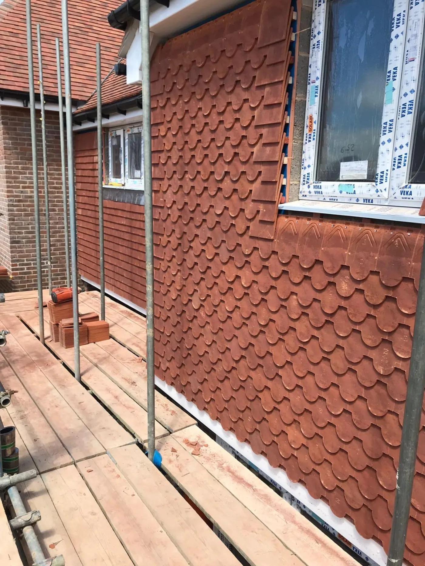 Hand-laid clay scallop tile-hanging to a gable elevation on a heritage property near Portsmouth