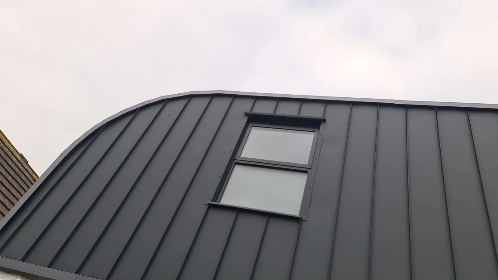 Standing-seam zinc commercial roof and cladding with curved ridge detail on a Hampshire commercial building