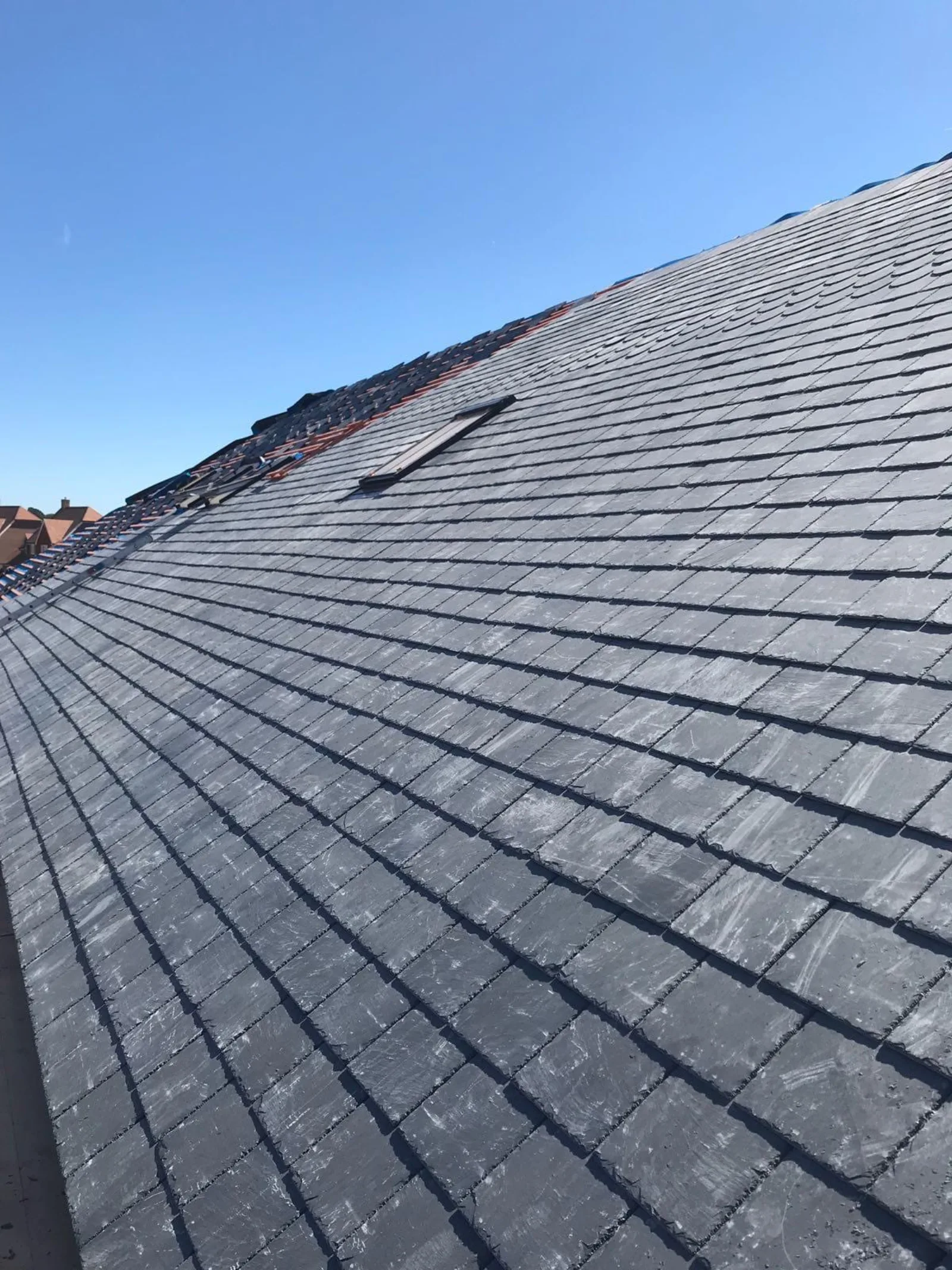Slate roof close-up with skylight — insurance claim inspection on a Hampshire property