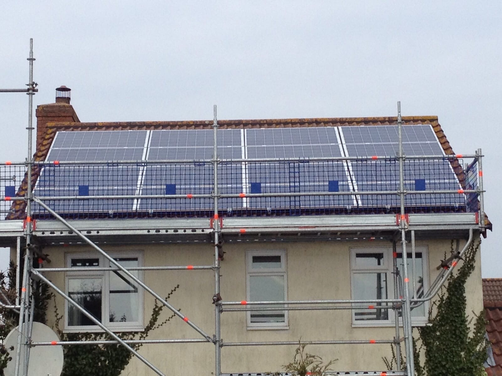 Roof-integrated solar panels fitted to a detached Hampshire home above original clay tiles
