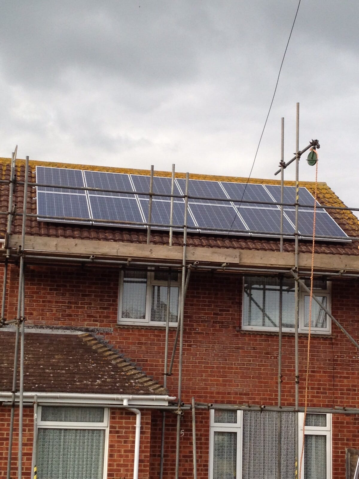 Two-row solar PV panel array installed on a Portsmouth semi-detached house roof with scaffolding in place